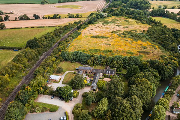 Aerial view of countryside with fields and buildings.