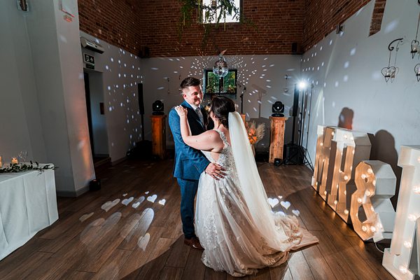 Couple's first dance with romantic lighting at wedding.