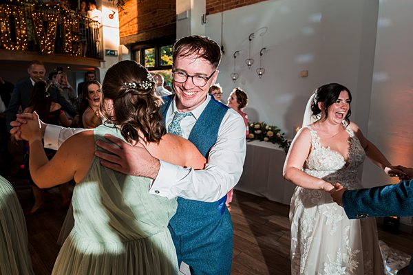Joyful wedding dance in a decorated venue.