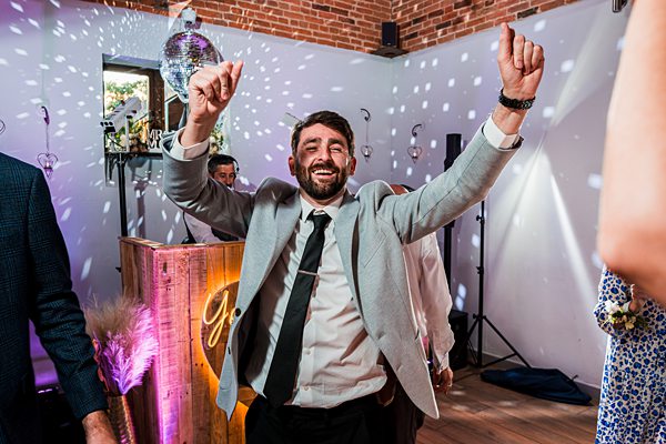 Man joyfully dancing at a party.