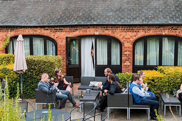 Group socialising outside brick building courtyard.