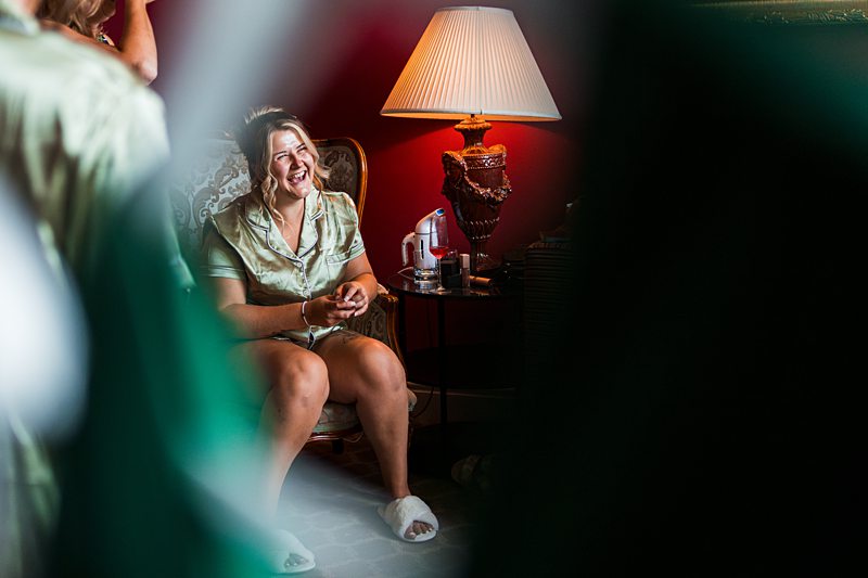 Woman in room with lamp, smiling and relaxed