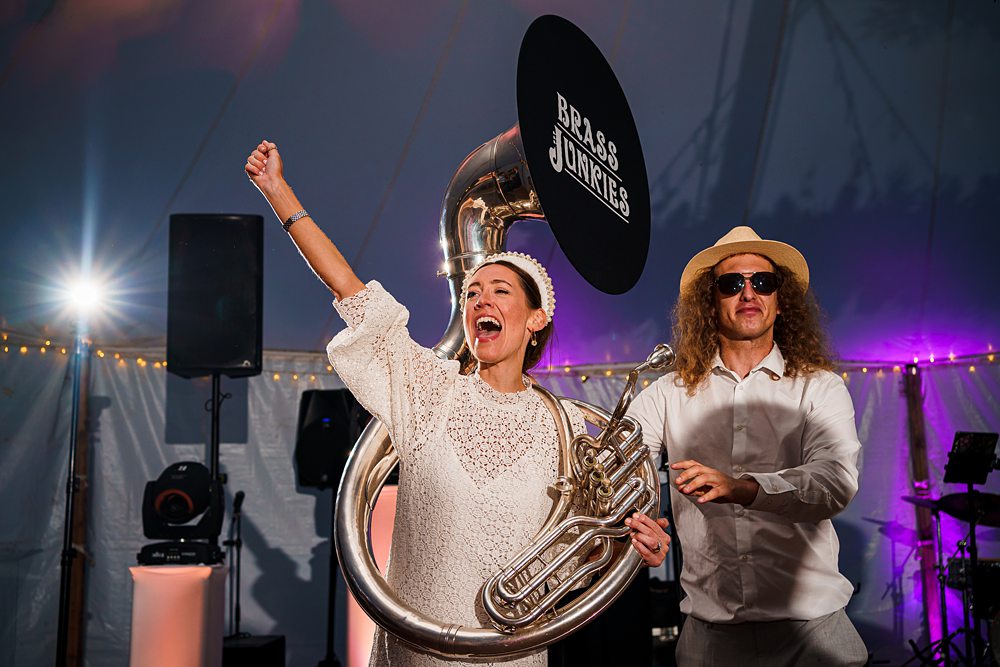 Musicians performing energetically at a lively event.