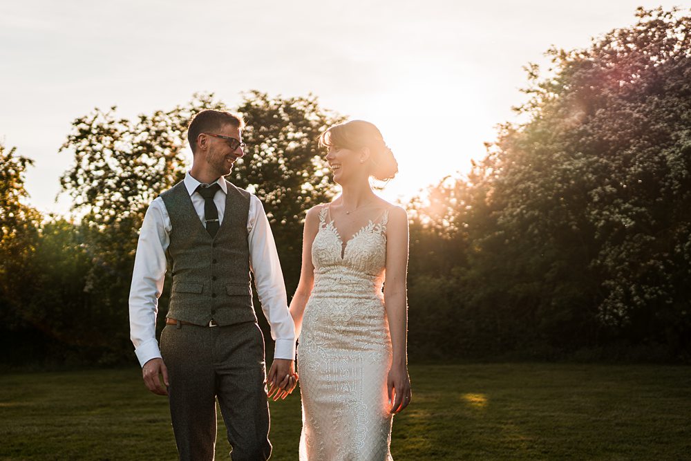 Couple holding hands in sunlit garden