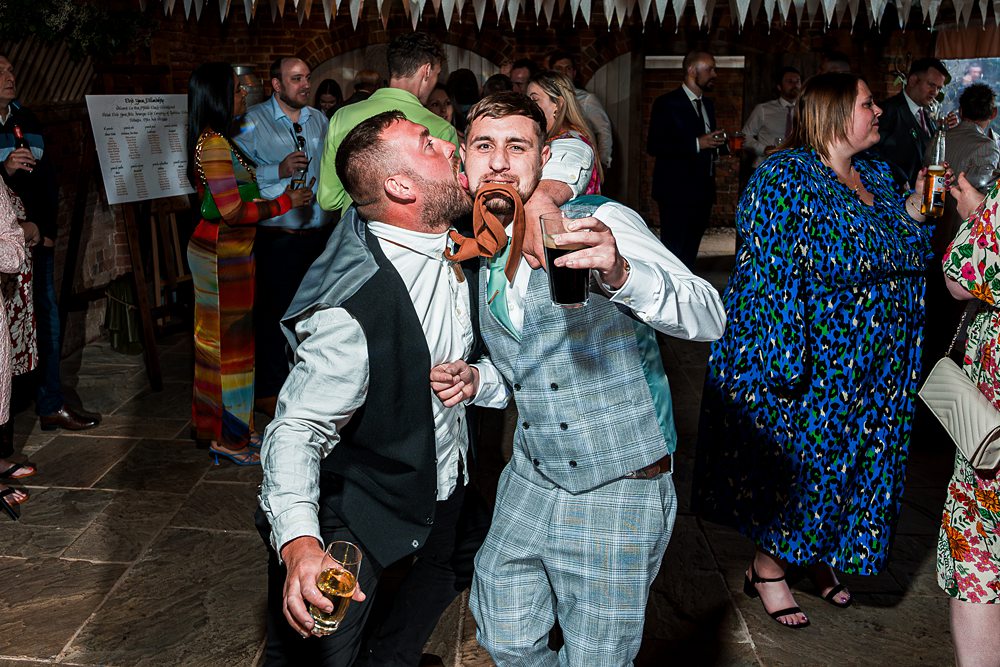 Two men dancing at lively party celebration.