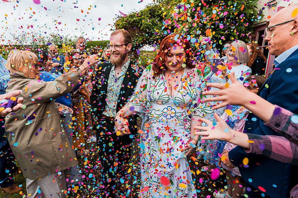 Colourful confetti shower at wedding celebration.