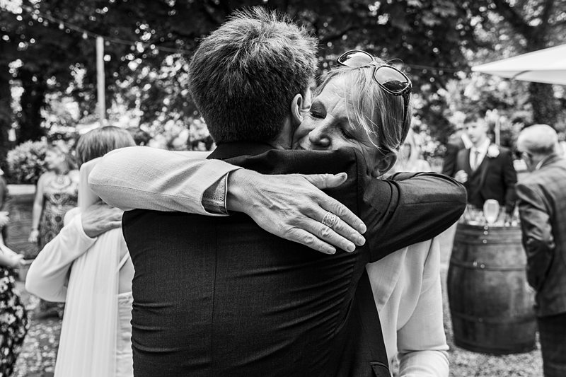 Black and white photo of two people hugging.