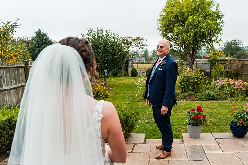 Bride and groom in garden ceremony setting.