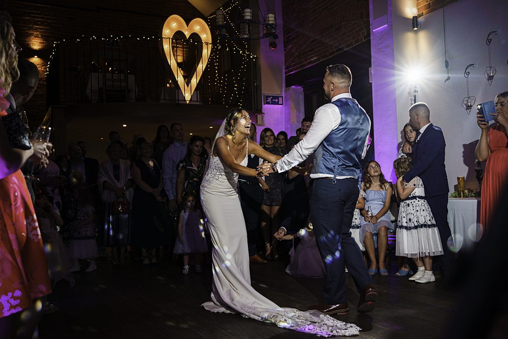 Bride and groom dancing at wedding reception.