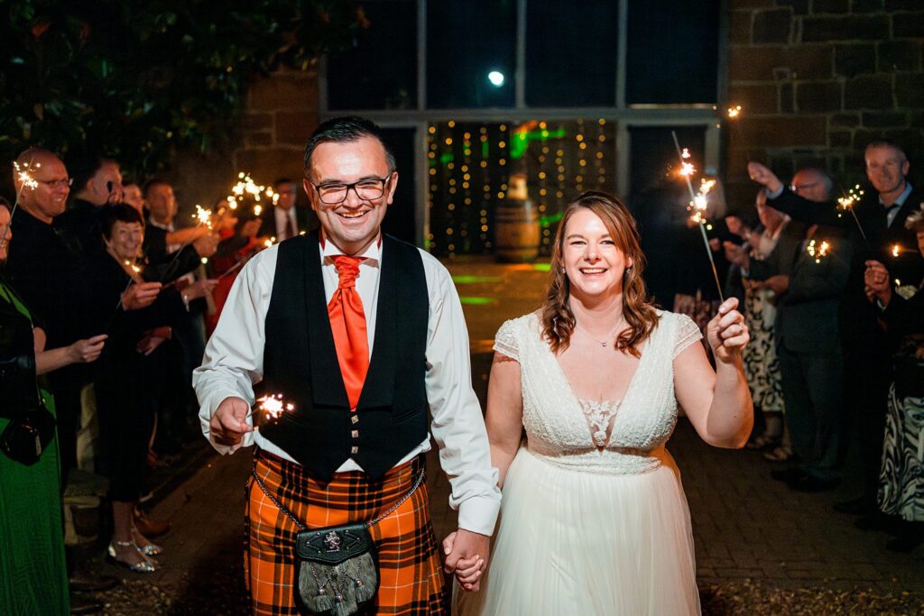 Bride and groom celebrating with sparklers