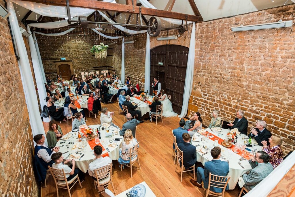 Rustic wedding reception with guests and decorated tables