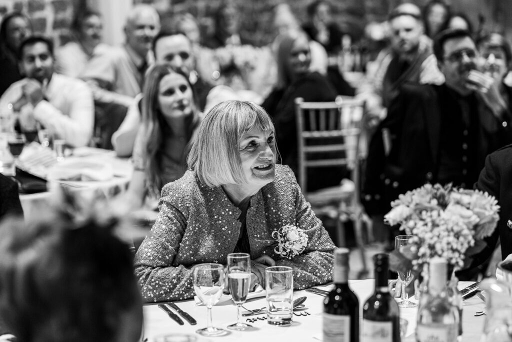 Smiling woman at a formal dinner event.