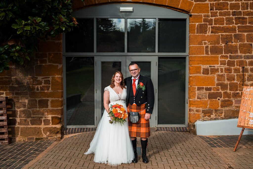 Bride and groom smiling in wedding attire