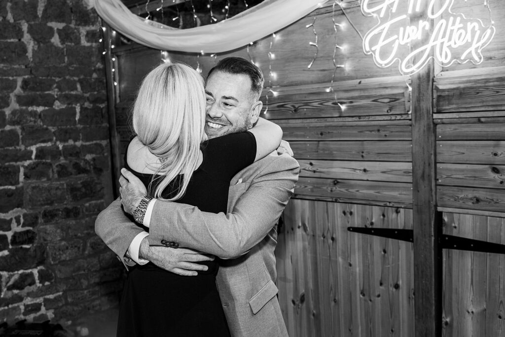 Couple hugging at a wedding celebration