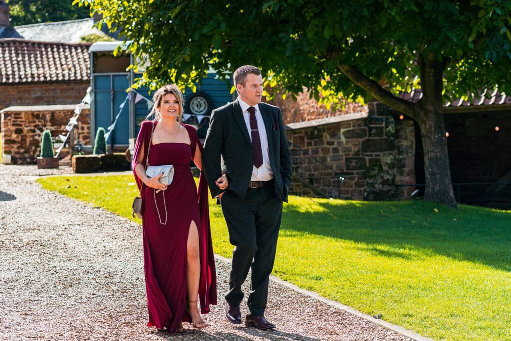 Couple walking outdoors dressed formally.