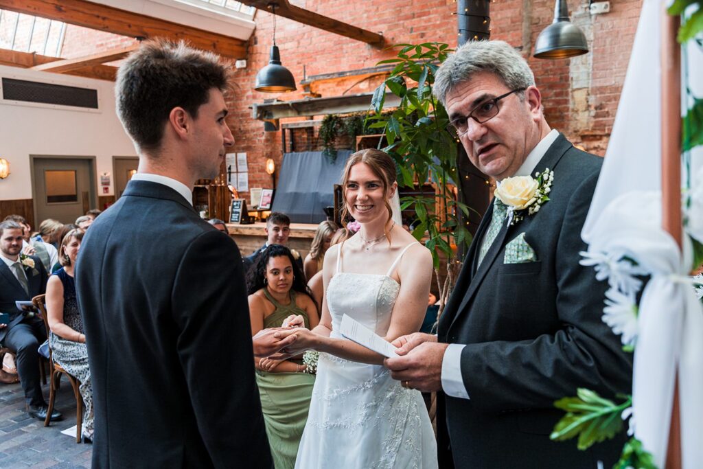 Couple exchanging vows in wedding ceremony.