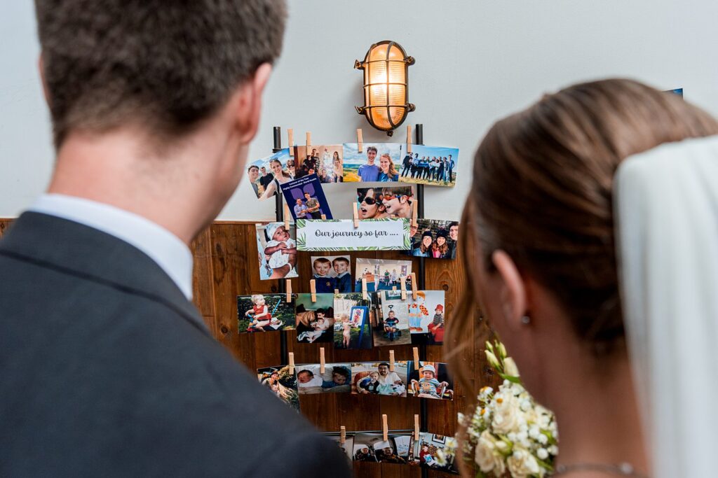 Couple views photo collage of their life journey.