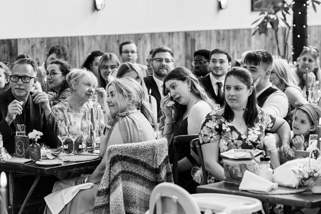 Group of wedding guests watching ceremony attentively.