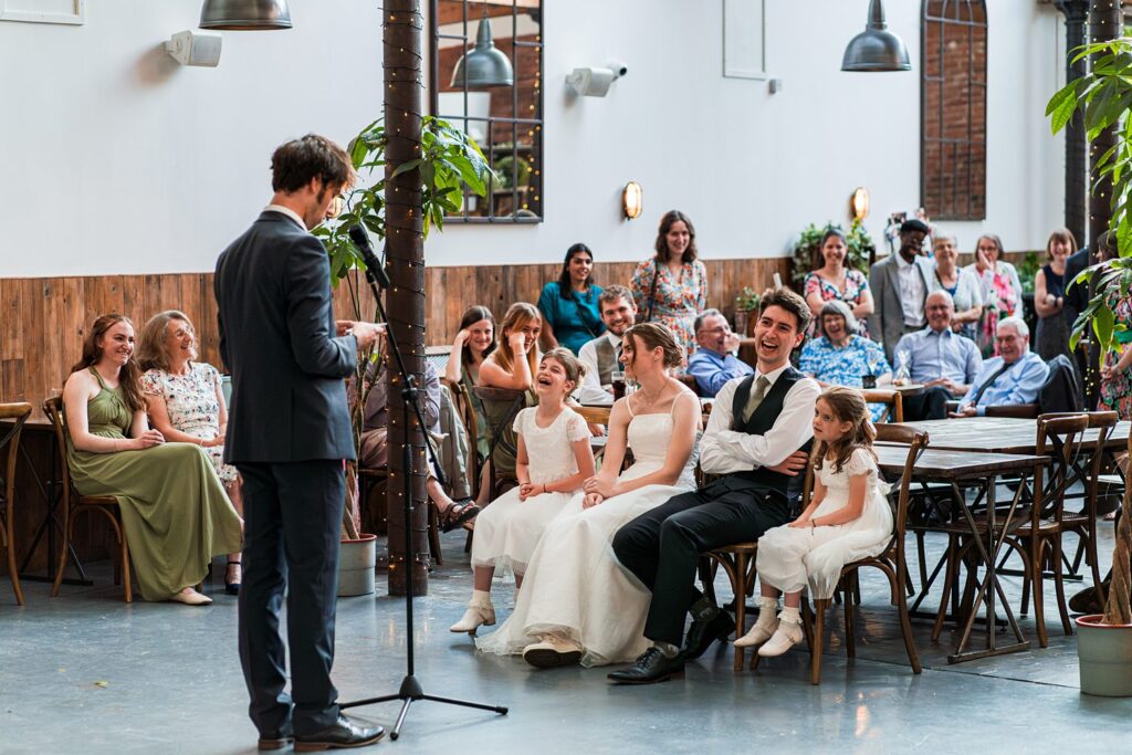 Wedding guests laughing during a speech