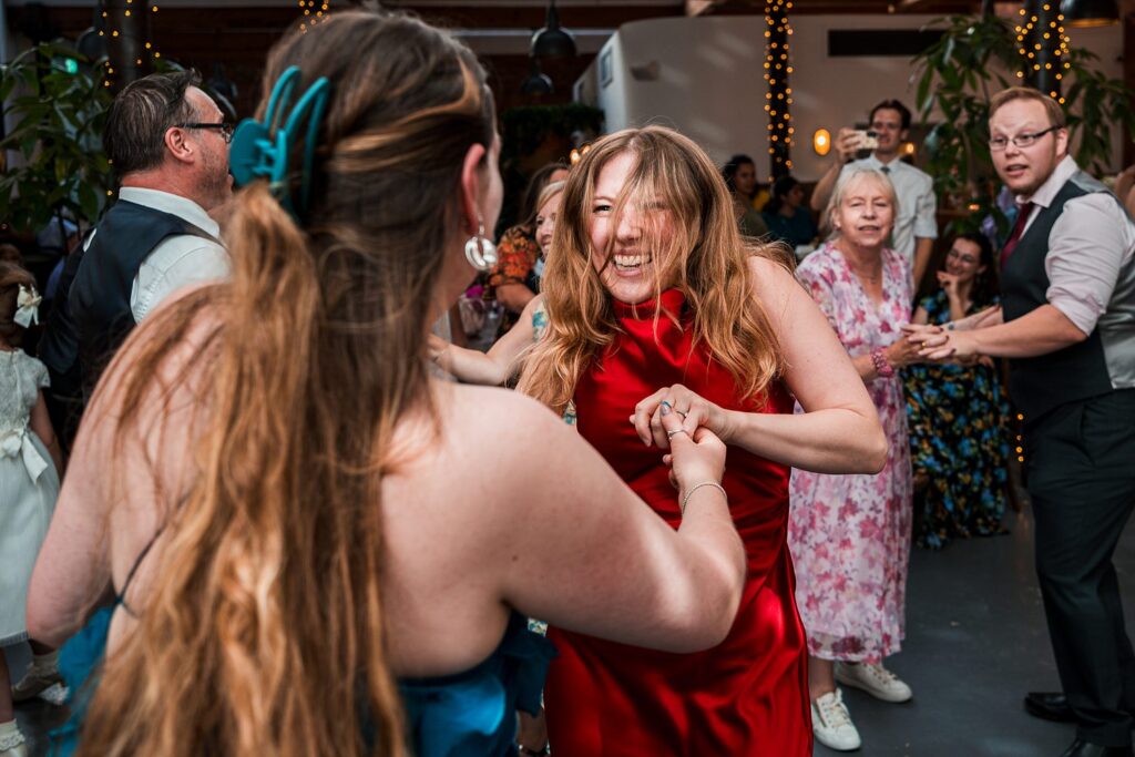 People joyfully dancing at a lively wedding party.