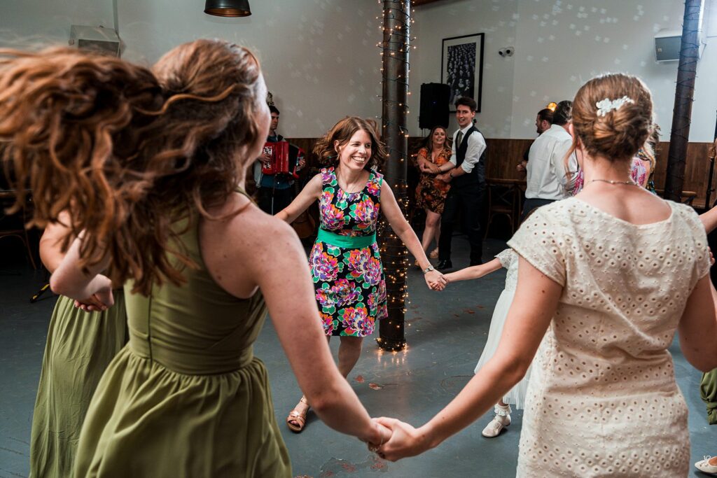 People holding hands and dancing in a circle.