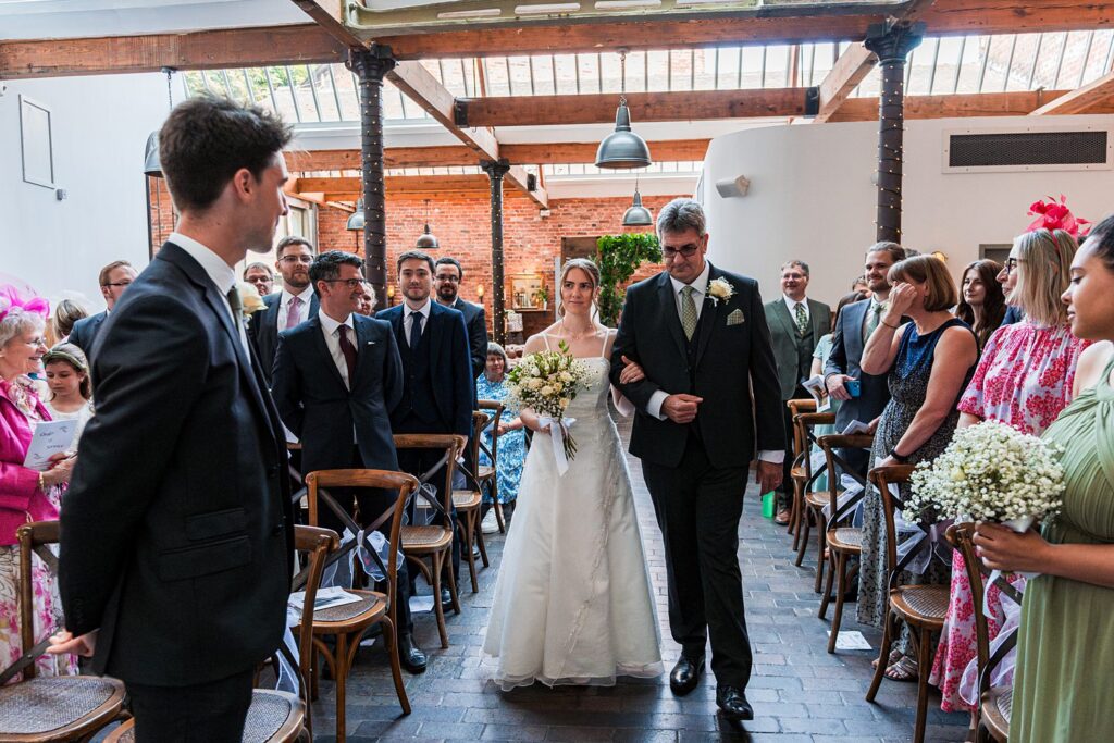 Bride walking down the aisle with father.