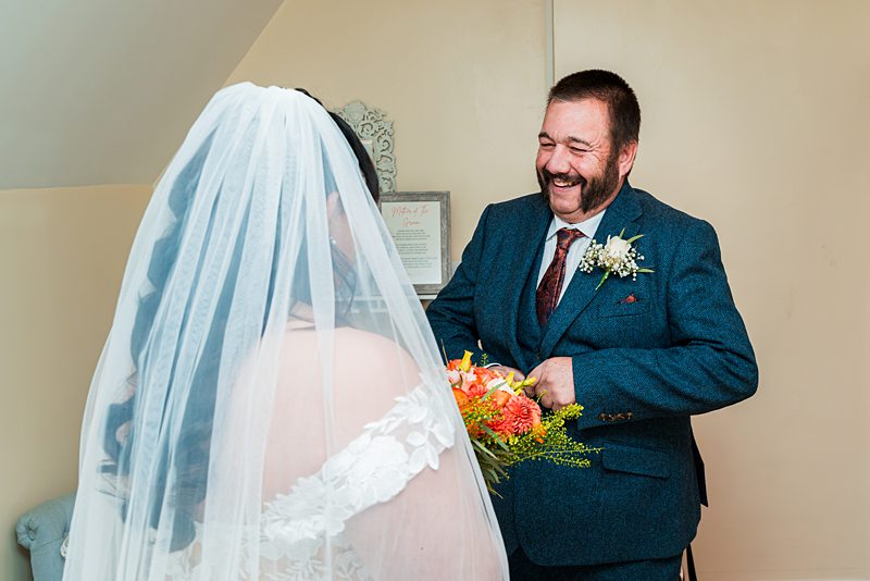 Bride and father sharing a joyous moment together.