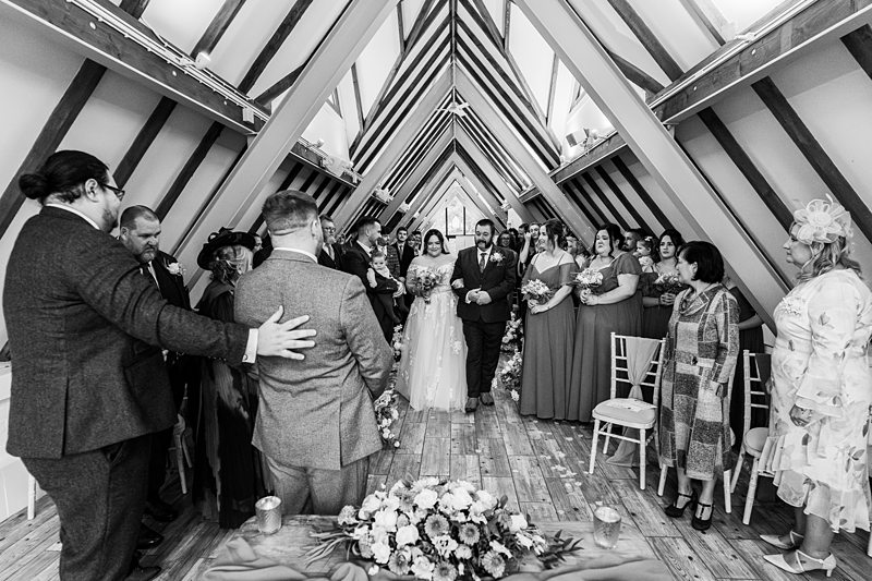 Bride and groom walking down the aisle together.