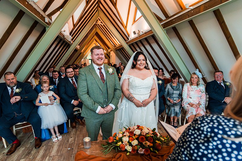 Bride and groom standing during wedding ceremony.
