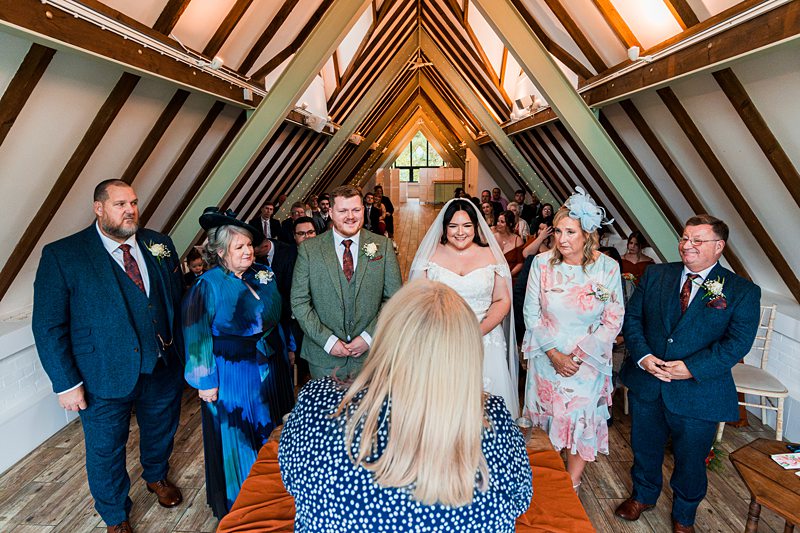Wedding ceremony in a rustic barn setting.