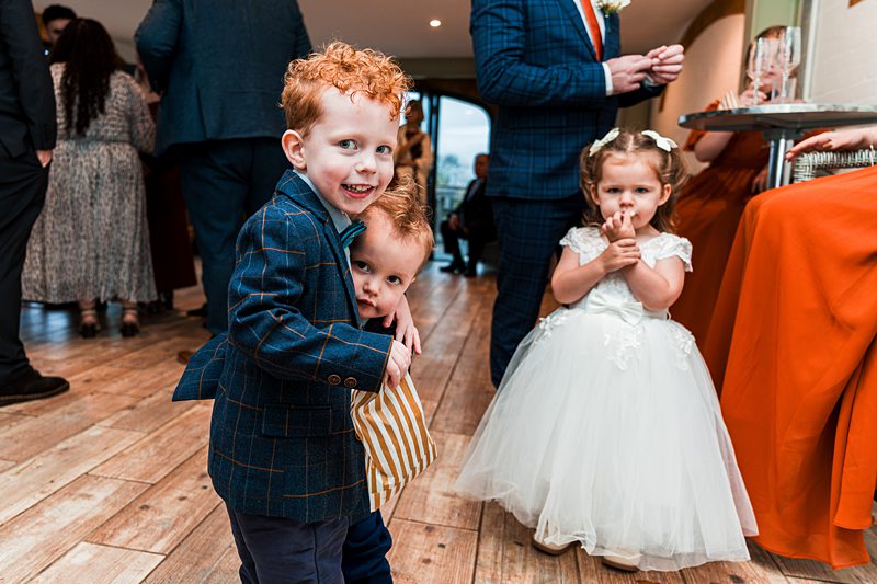Children enjoying a wedding celebration indoors.