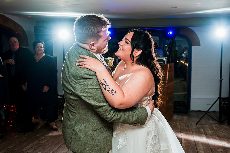 Bride and groom share first dance at wedding.