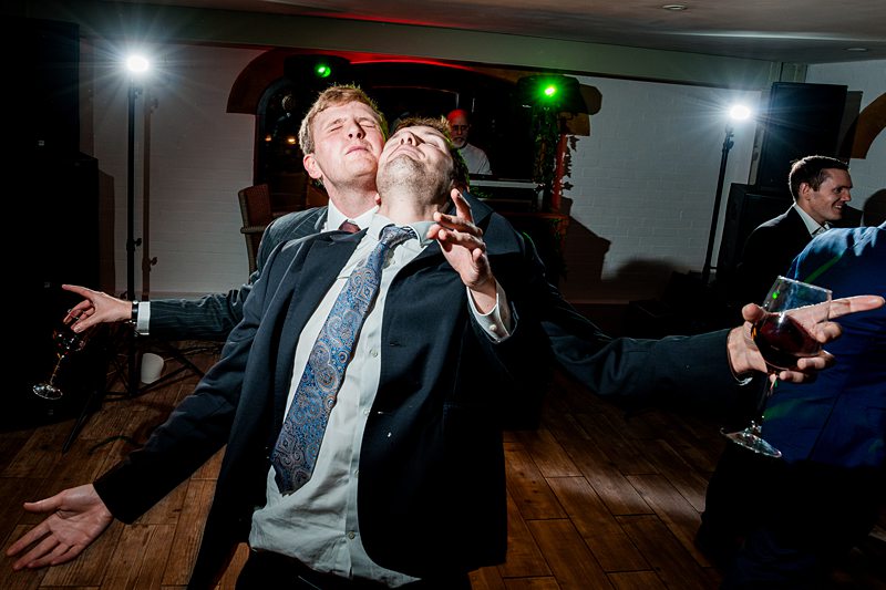 Two men dancing energetically at a party.