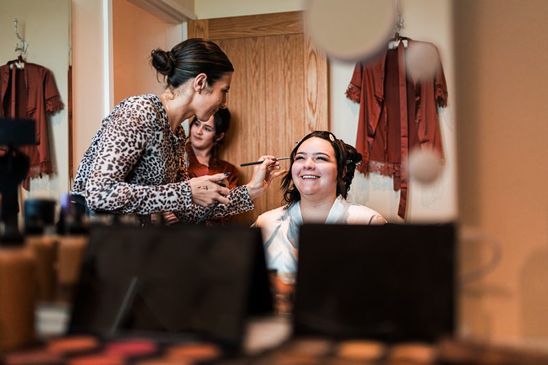 Woman getting makeup done before an event.