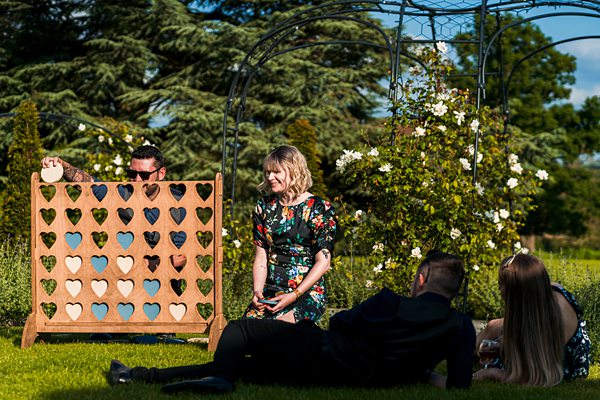 People playing giant connect four outdoors.