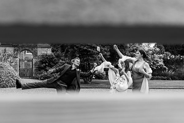 Fun outdoor group dancing celebration at a wedding.