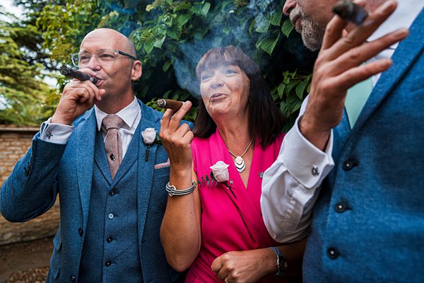 People enjoying cigars at a celebration outdoors.