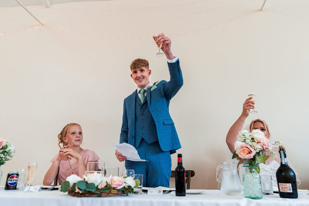 Man making a toast at wedding reception.