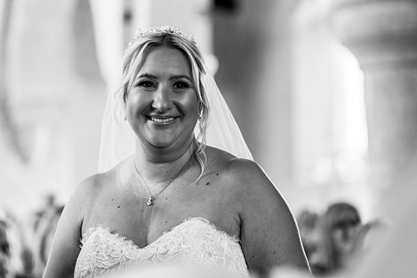 Bride smiling in elegant wedding dress