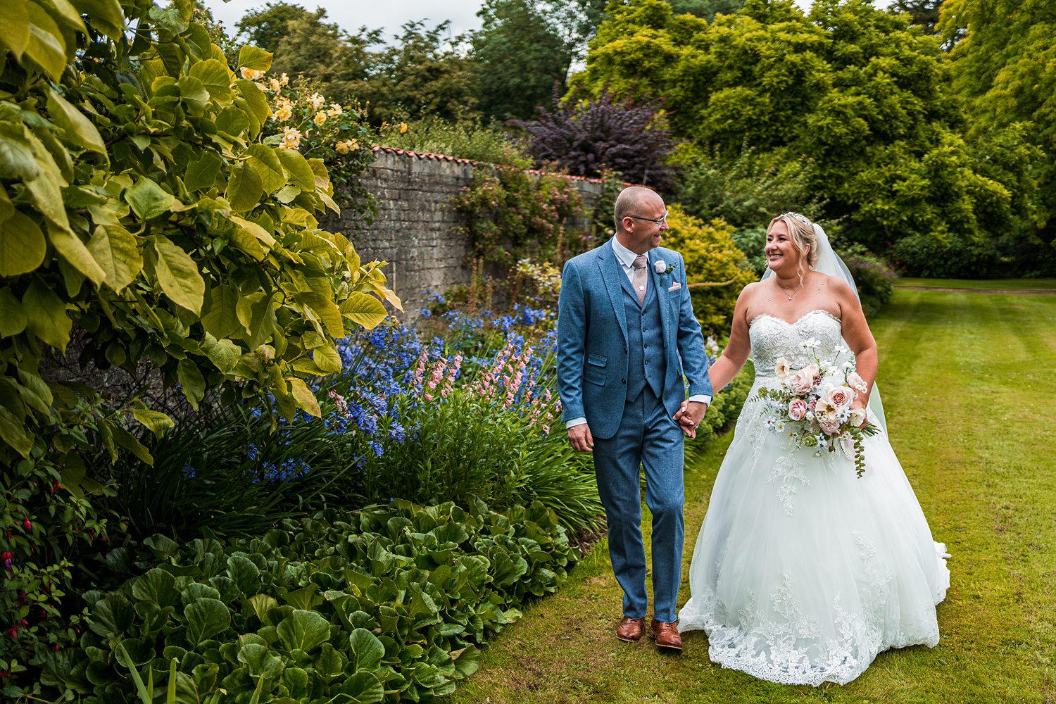 Bride and groom walking in garden