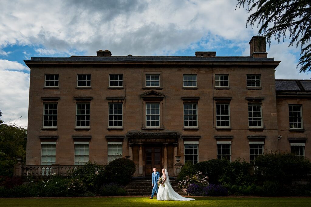 Bride and groom outside historic manor house