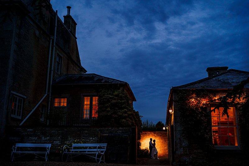 Silhouetted couple in courtyard at dusk
