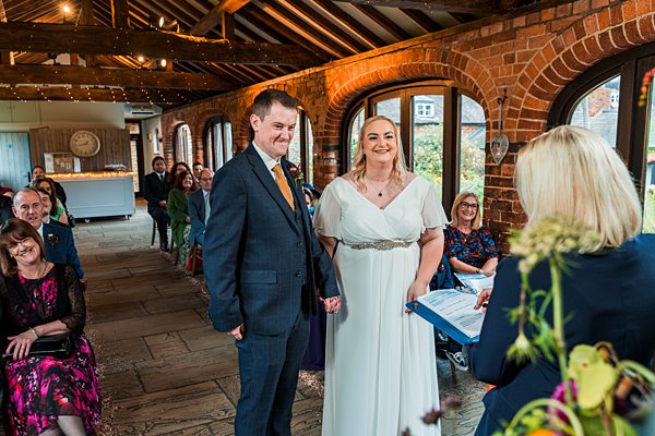 Bride and groom during indoor wedding ceremony.
