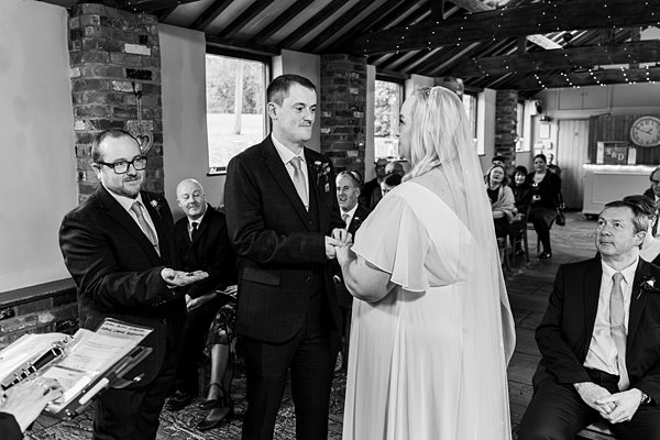 Couple exchanging vows in wedding ceremony.
