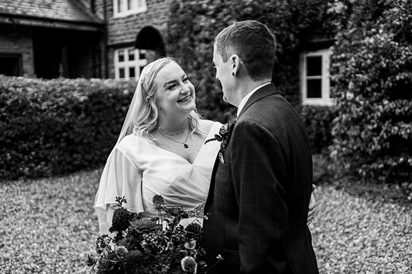 A joyful couple on their wedding day outside.