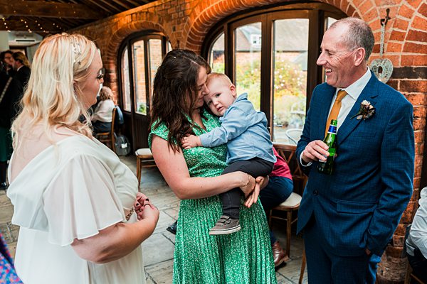 Guests socialising at a wedding reception indoors.