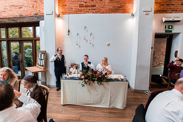 Wedding reception with bride, groom and guests.