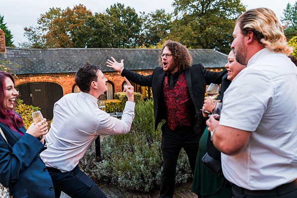 Group of friends laughing and socialising outdoors.