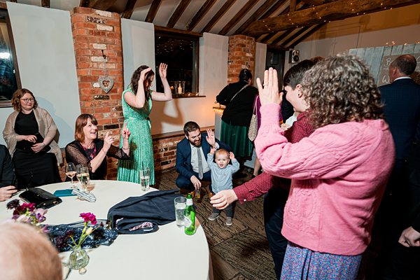 People dancing and celebrating at a party indoors.