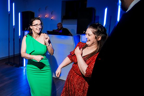 Two women dancing at a party.